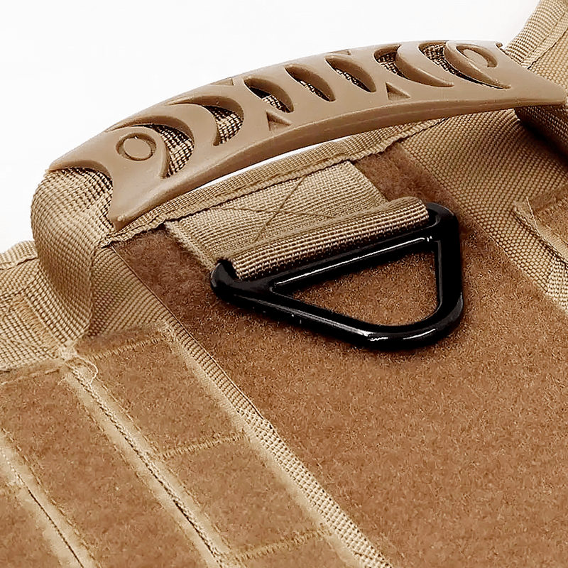 Close-up of a brown dog harness handle with a black metal D-ring for leash attachment and reinforced Molle panels