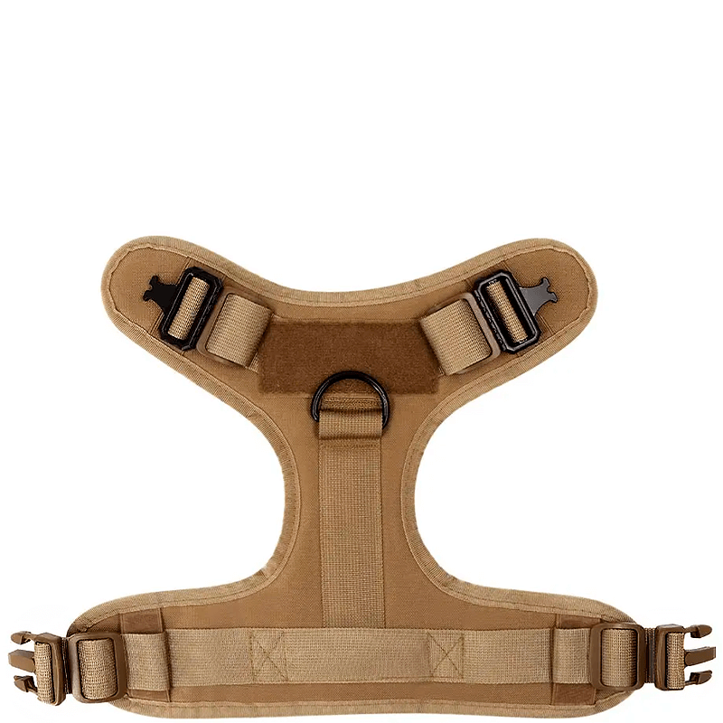 Underside view of a brown tactical dog harness with adjustable straps, sturdy buckles, and a central D-ring for leash attachment.