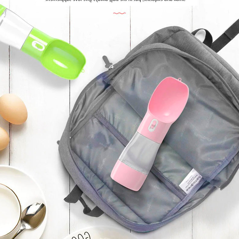 A PetPal Water & Snack Bottle placed next to a backpack, highlighting its portability for travel.