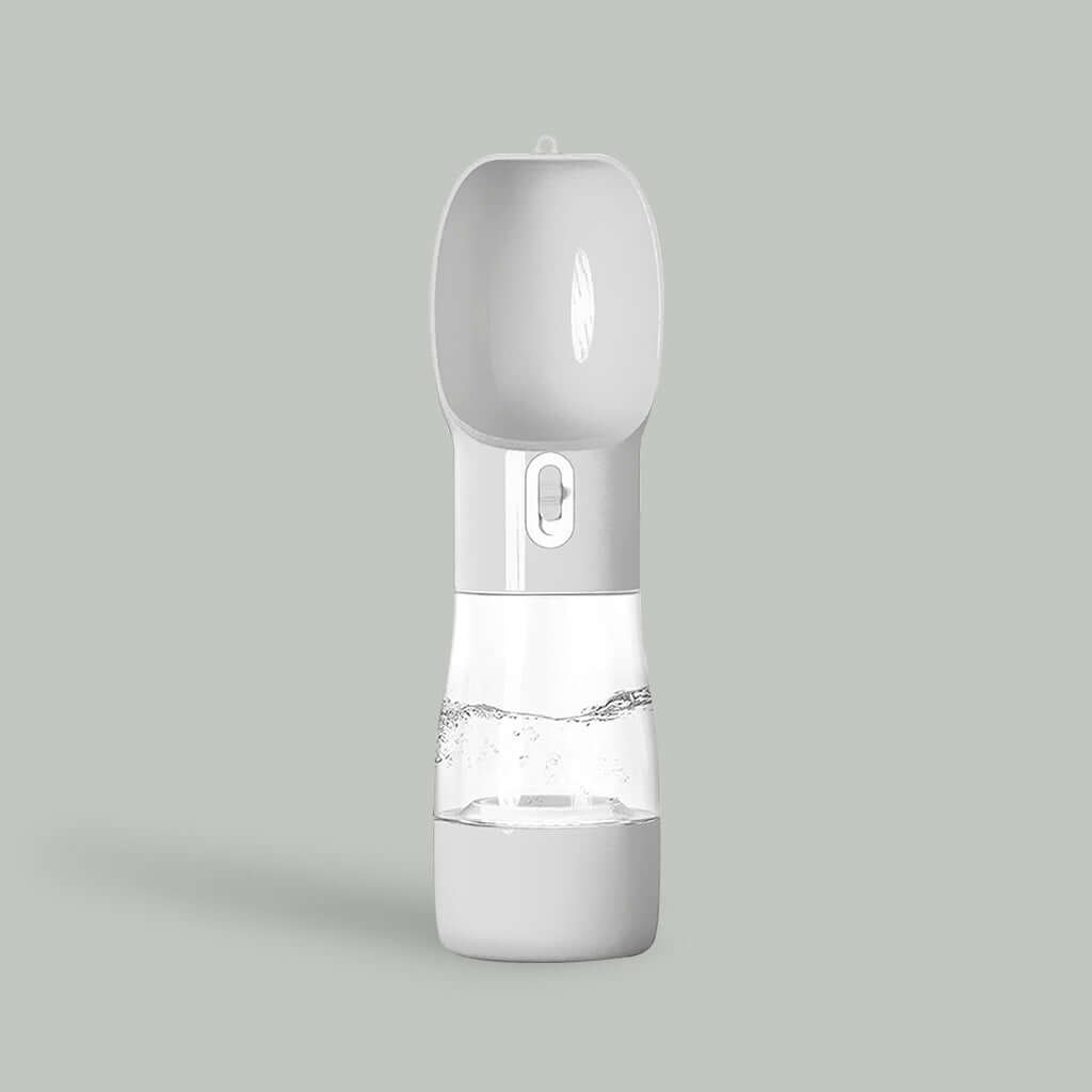 Light gray PetPal Water & Snack Bottle with flip-up spout, water dispensing button, and transparent midsection against a matching background.