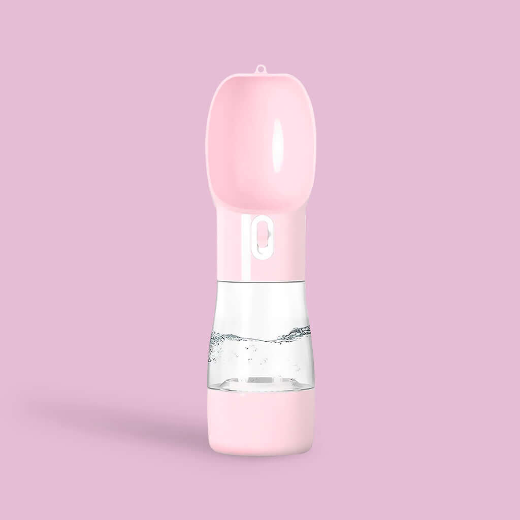 Pink PetPal Water & Snack Bottle with flip-up spout, water dispensing button, and transparent midsection against a matching background.