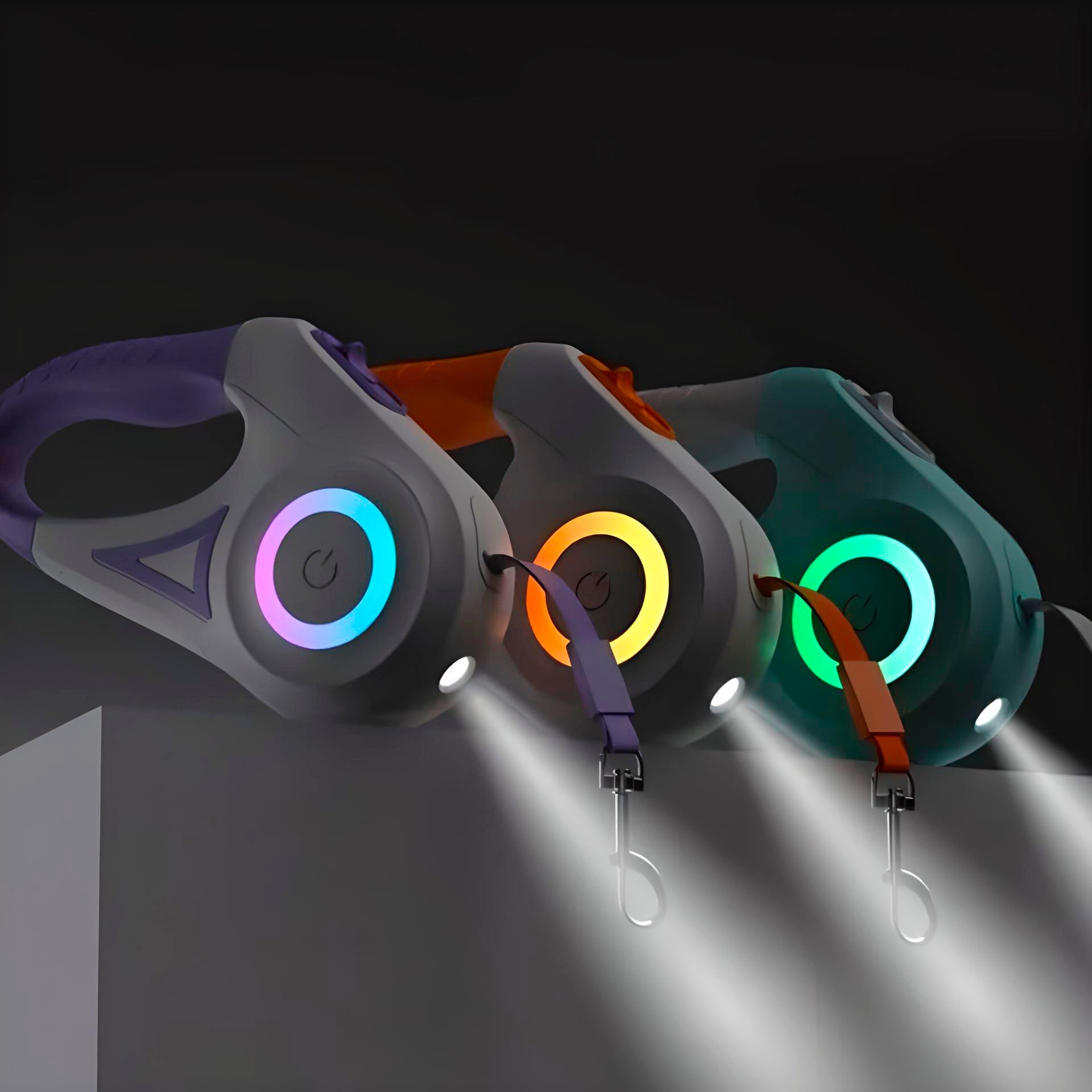 Three NightSafe RGB Light Retractable Leashes with illuminated power symbols (blue, yellow, green) and built-in LED lights in a dark setting.